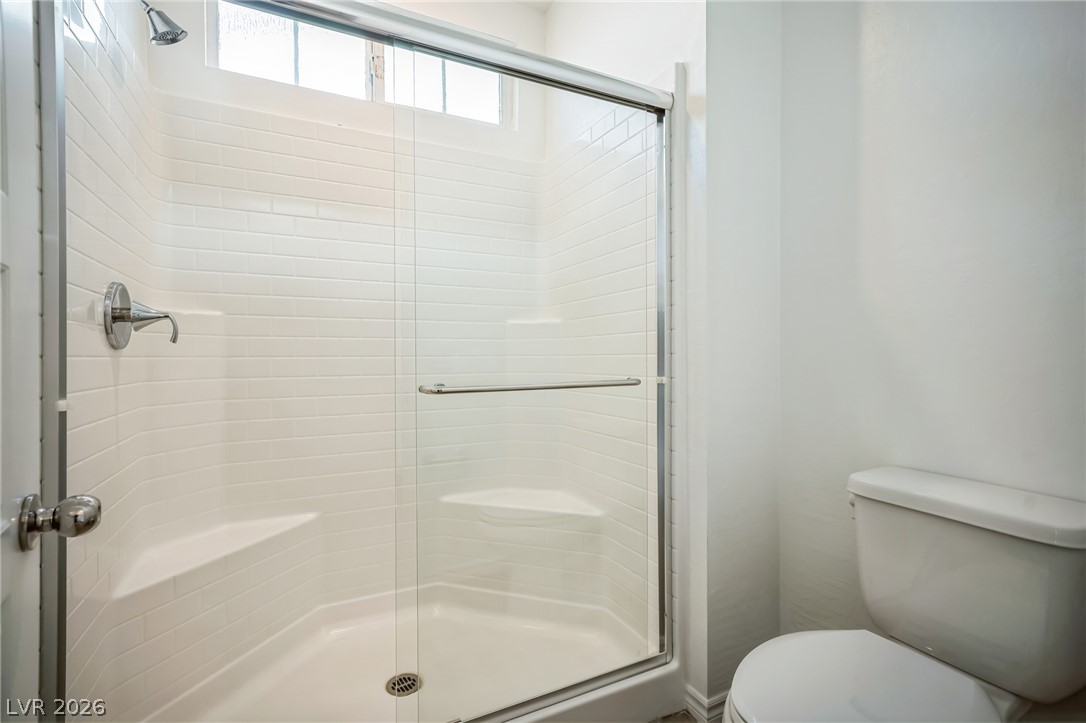 7348 North Decatur Boulevard, Unit 1 North Las Vegas, NV 89084 - Photo 14 of 17 A well-appointed shower stall features white subway tile and a practical built-in bench.