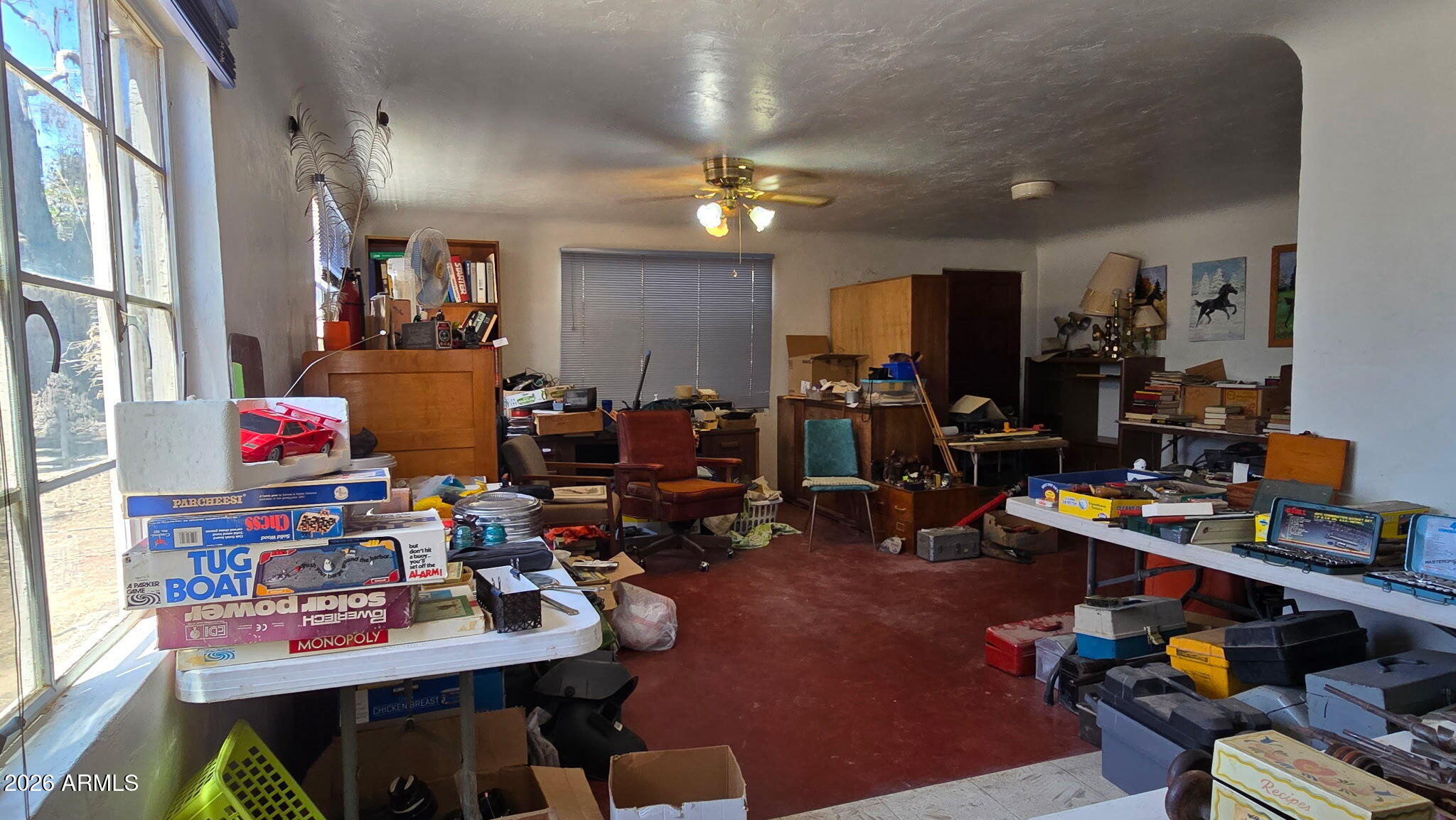 6803 South Miller Road Buckeye, AZ 85326 - Photo 9 of 50 a work room with lots of furniture and clutter