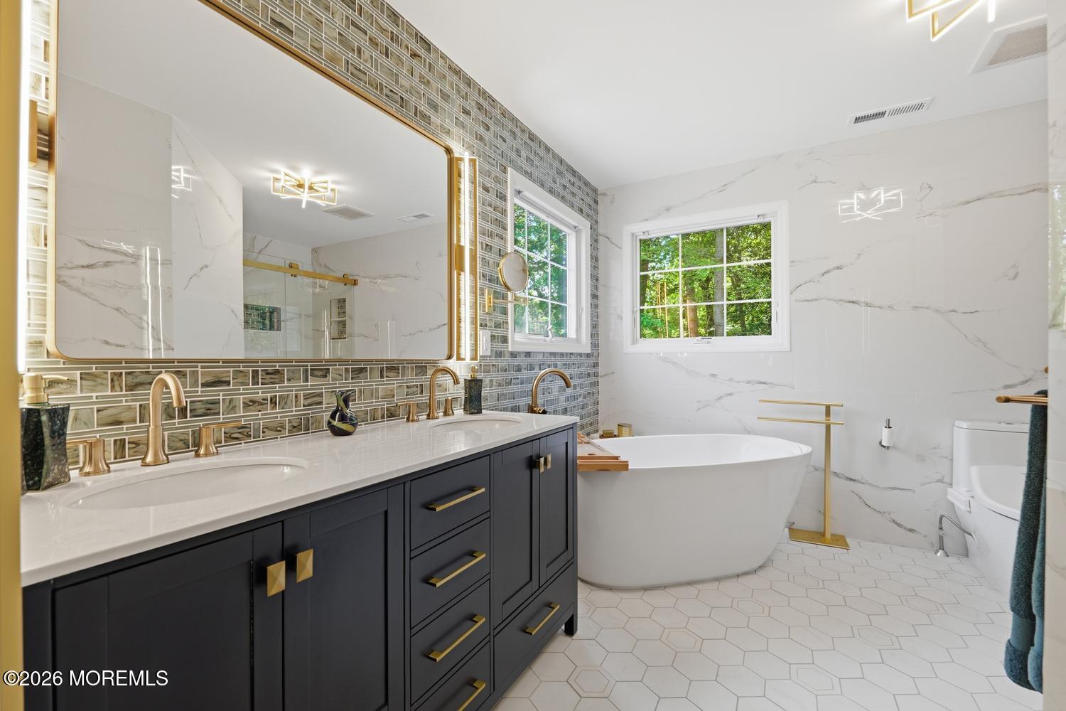 7 Cherry Tree Lane Cream Ridge, NJ 08514 - Photo 22 of 47 a spacious bathroom with a double vanity sink a large mirror and a bathtub