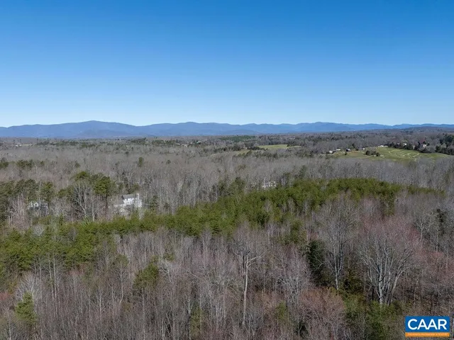 a view of a lake and green valley