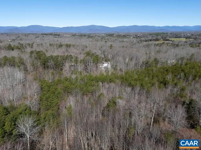 a view of a lush green field and a mountain view