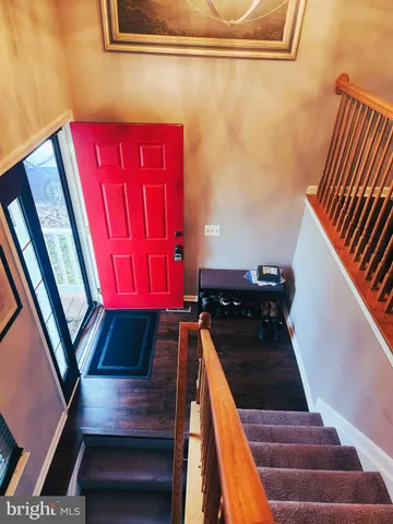a view of a balcony with chairs and wooden floor