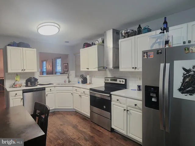 a kitchen with a sink appliances and cabinets