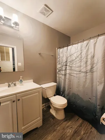 a bathroom with a sink toilet and a mirror