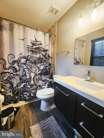 a bathroom with a sink toilet and shower