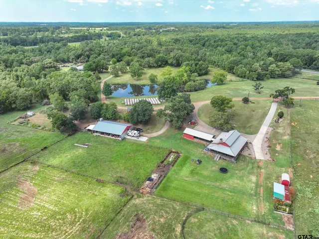 a view of a house with pool and a yard