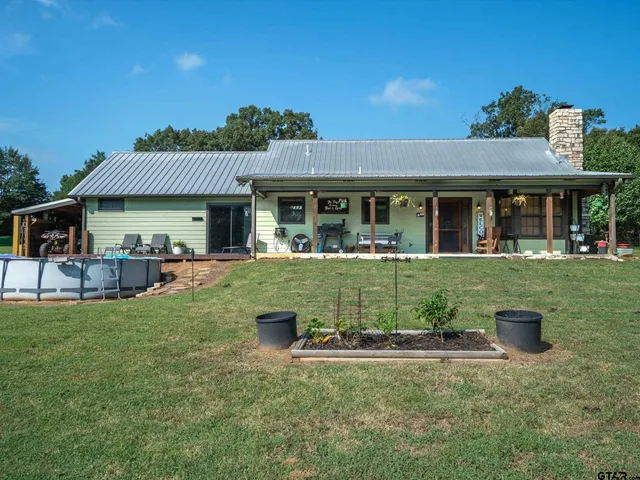 a view of a house with a yard and floor to ceiling window