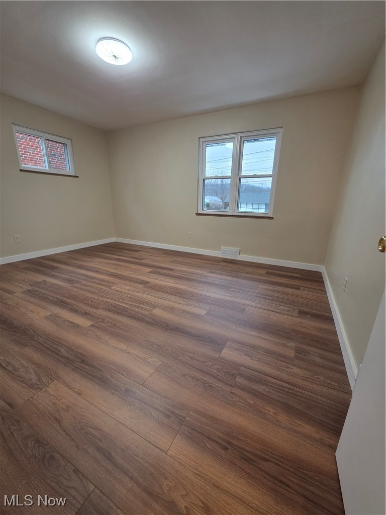 Bedroom featuring wood finished floors and plenty of natural light