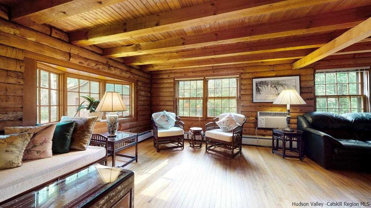 296 Bush Road Stone Ridge, NY 12484 - Photo 11 of 27 a living room with furniture floor to ceiling window and wooden floor