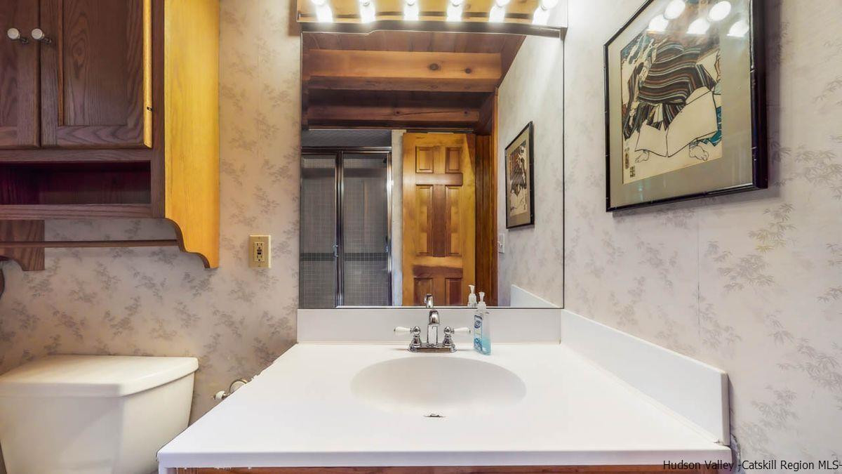 296 Bush Road Stone Ridge, NY 12484 - Photo 17 of 27 a bathroom with a sink and a mirror