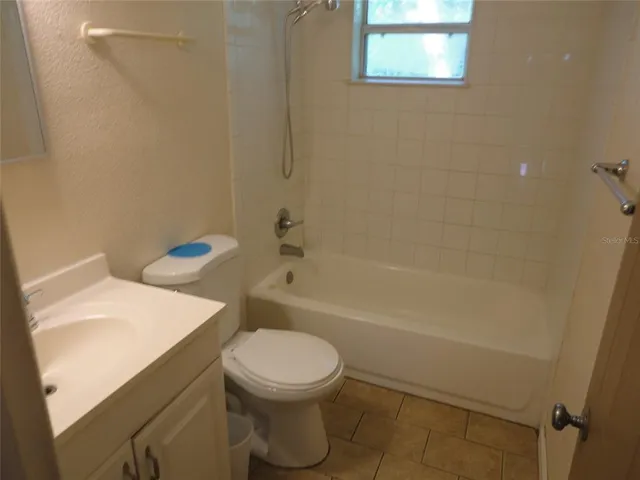 a bathroom with a toilet a sink and bathtub