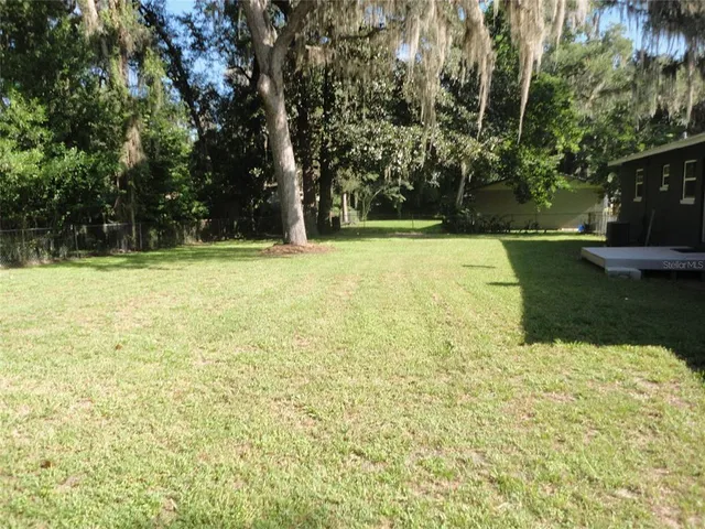 a view of a yard with an outdoor space