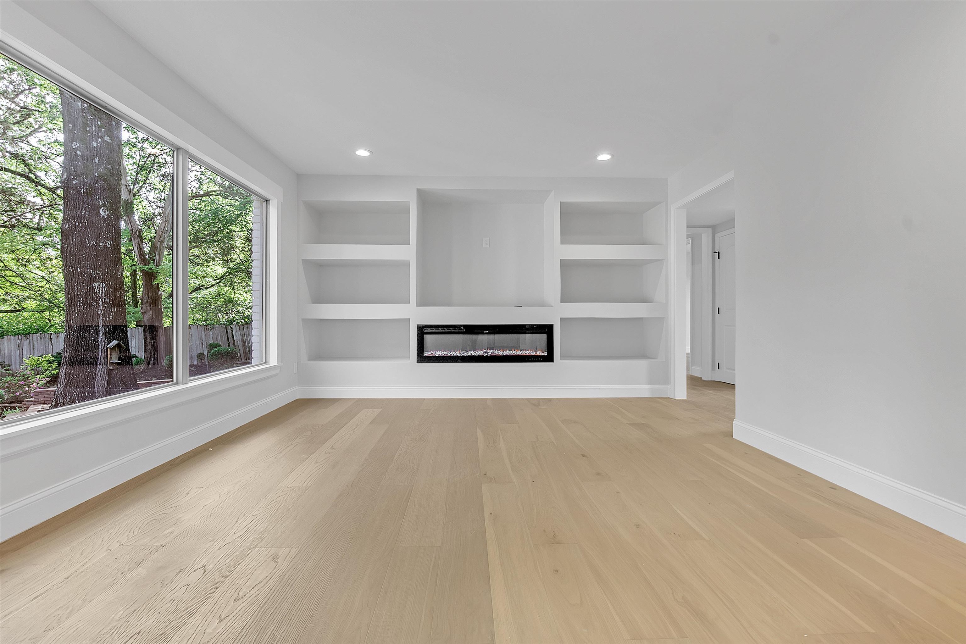 5385 Walnut Grove Road Memphis, TN 38120 - Photo 12 of 39 a view of an empty room with a window and wooden floor