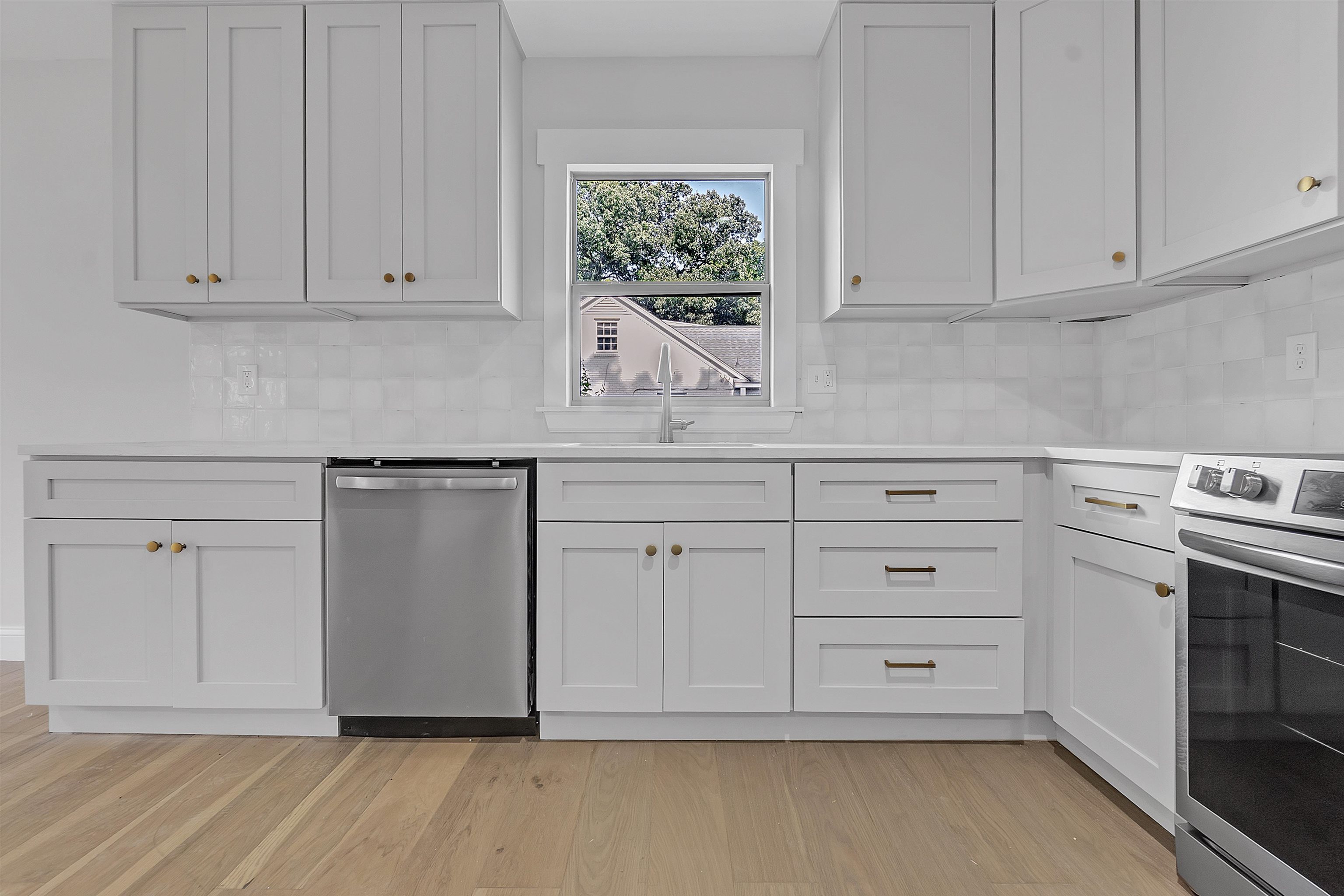 5385 Walnut Grove Road Memphis, TN 38120 - Photo 14 of 39 a kitchen with white cabinets and a stove