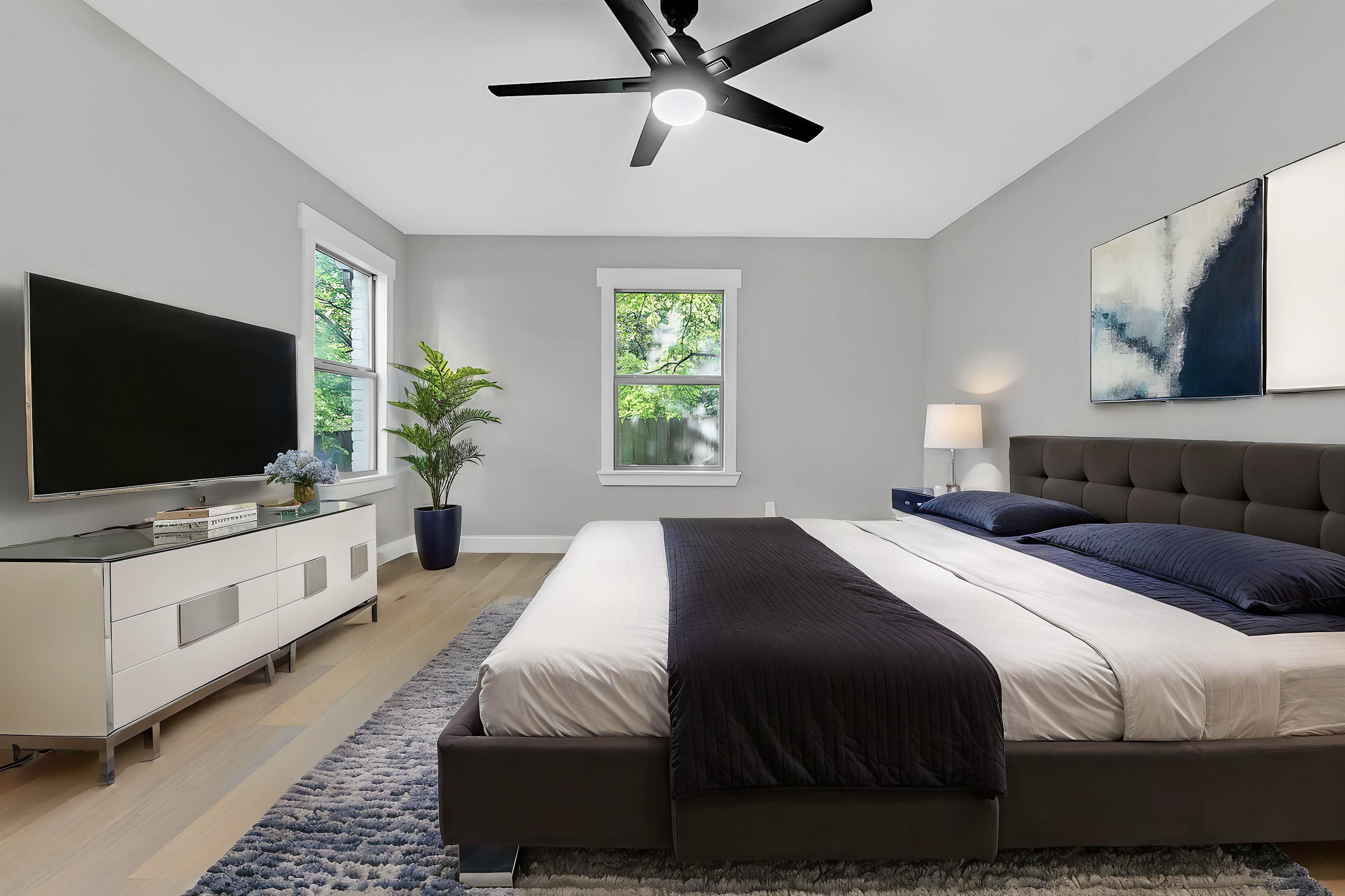 5385 Walnut Grove Road Memphis, TN 38120 - Photo 22 of 39 a bedroom with a large bed and a flat screen tv
