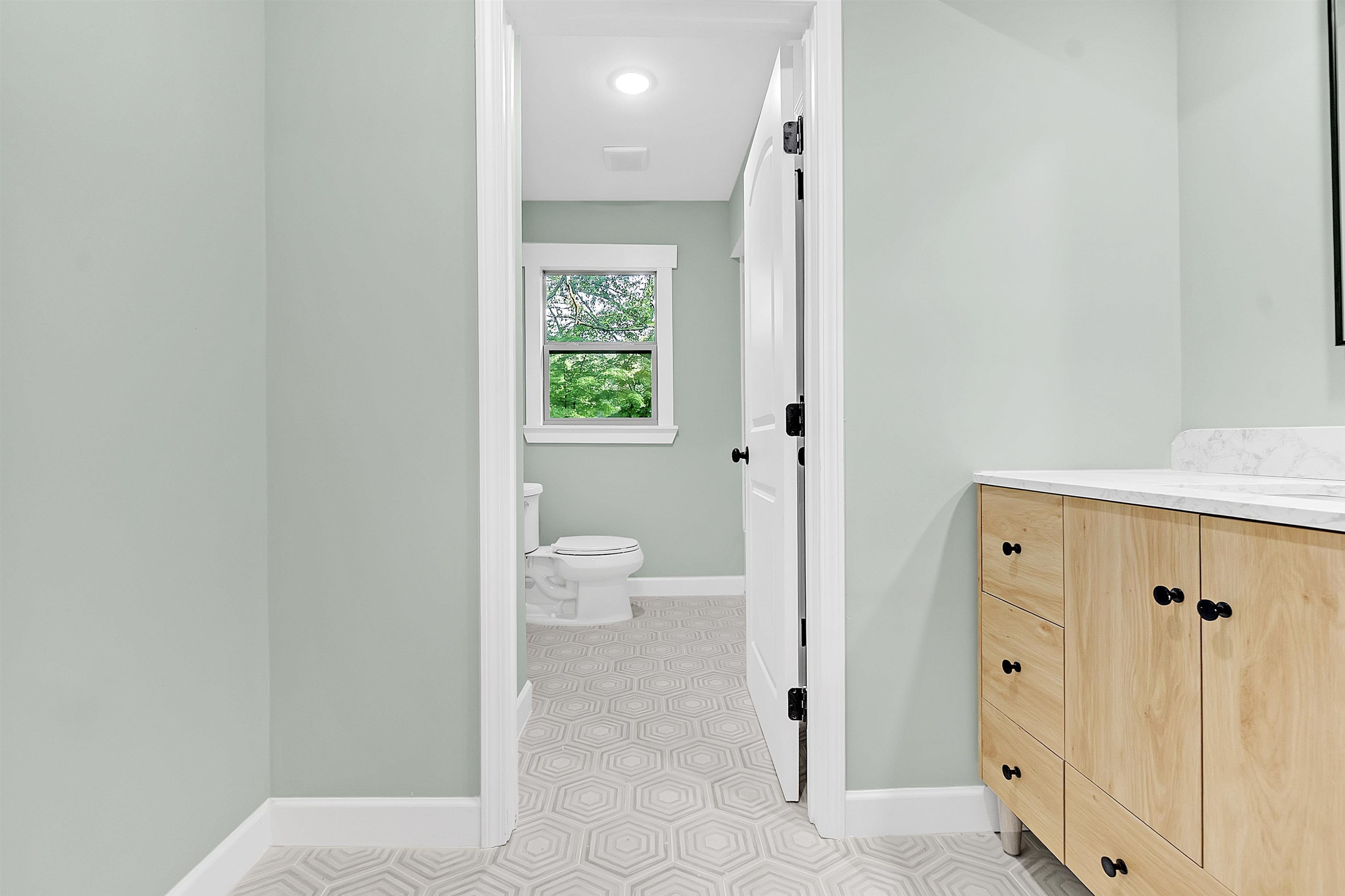 5385 Walnut Grove Road Memphis, TN 38120 - Photo 29 of 39 a view of a bathroom with a toilet sink and a mirror