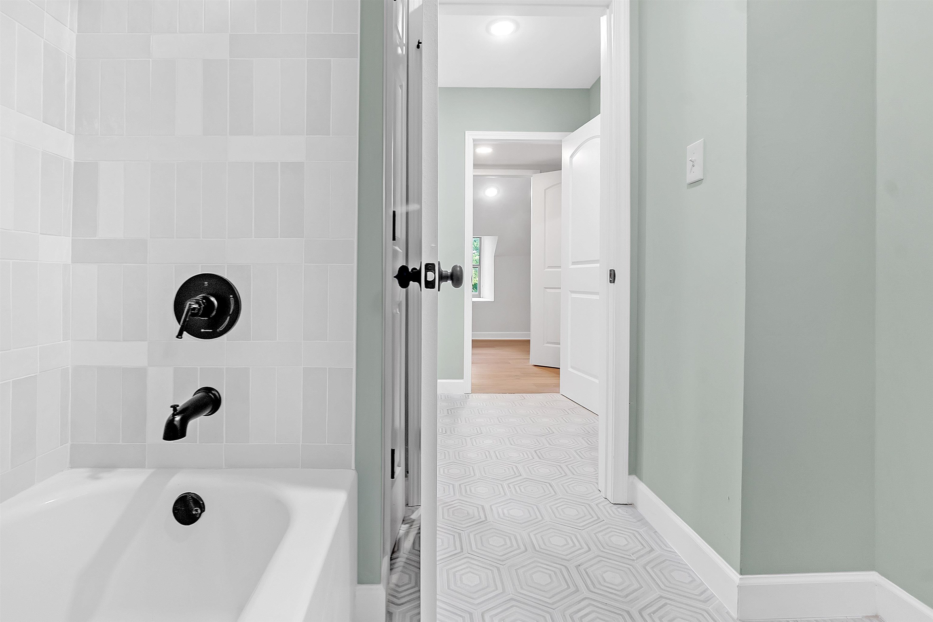 5385 Walnut Grove Road Memphis, TN 38120 - Photo 30 of 39 a bathroom with a tub sink shower and mirror