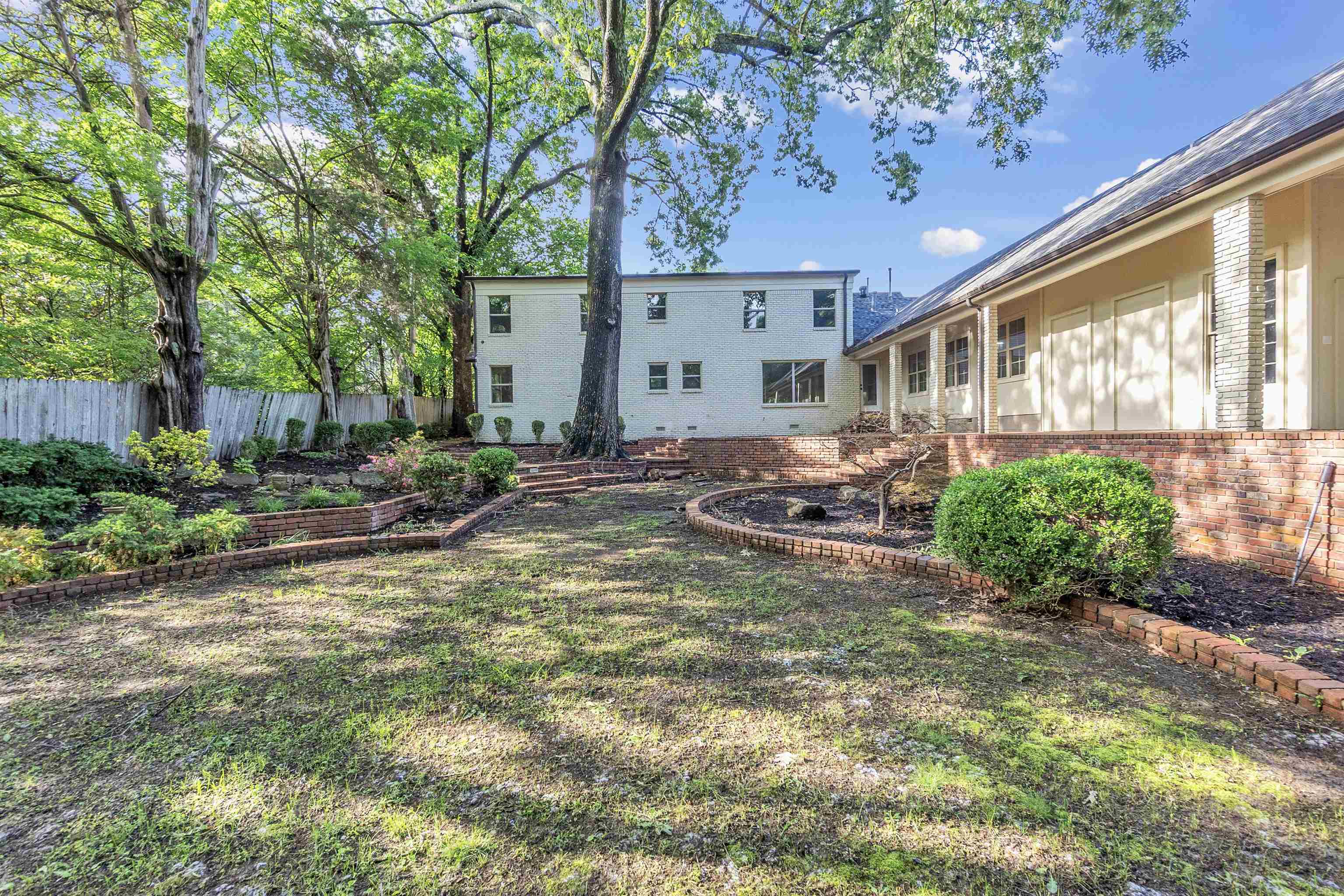 5385 Walnut Grove Road Memphis, TN 38120 - Photo 36 of 39 a backyard of a house with yard and outdoor seating