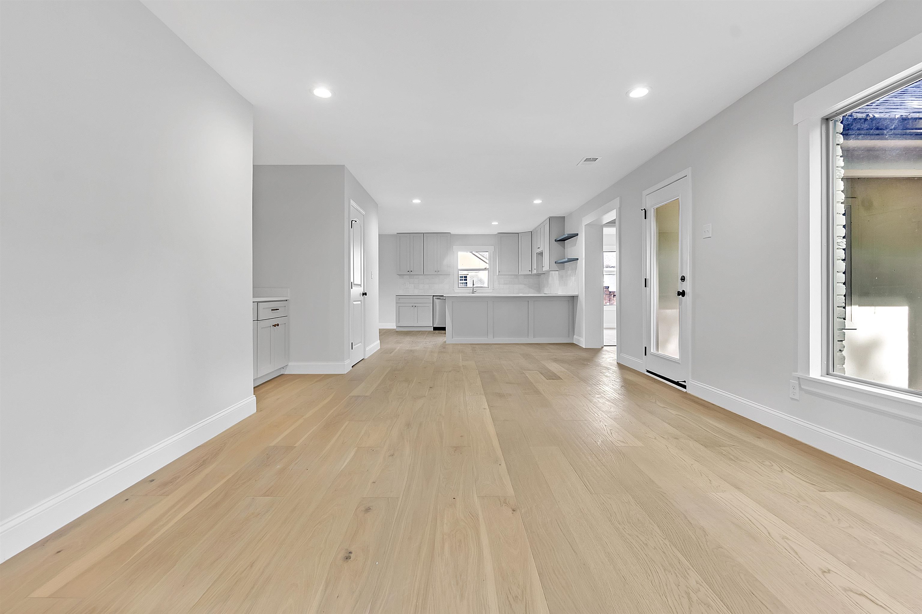 5385 Walnut Grove Road Memphis, TN 38120 - Photo 5 of 39 a view of empty room with wooden floor and windows