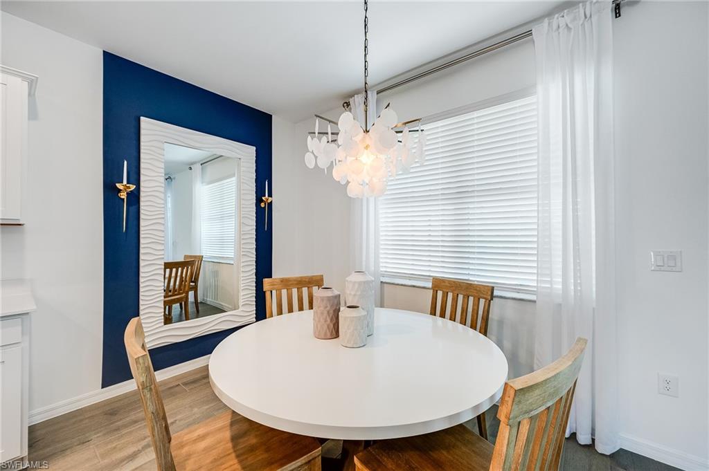 2318 Avocado Lane Naples, FL 34120 - Photo 12 of 47 a view of a dining room with furniture and wooden floor