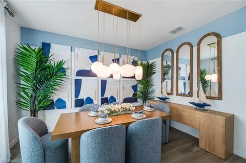 a living room with furniture fireplace and potted plants