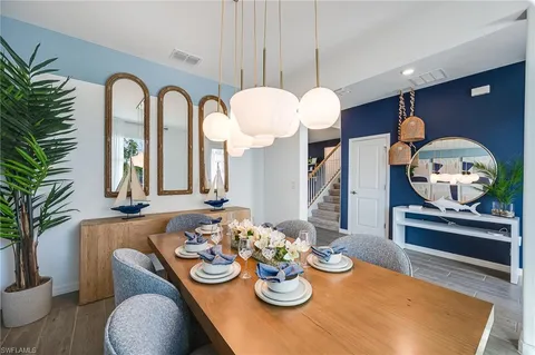 a view of a dining room with furniture and a potted plant