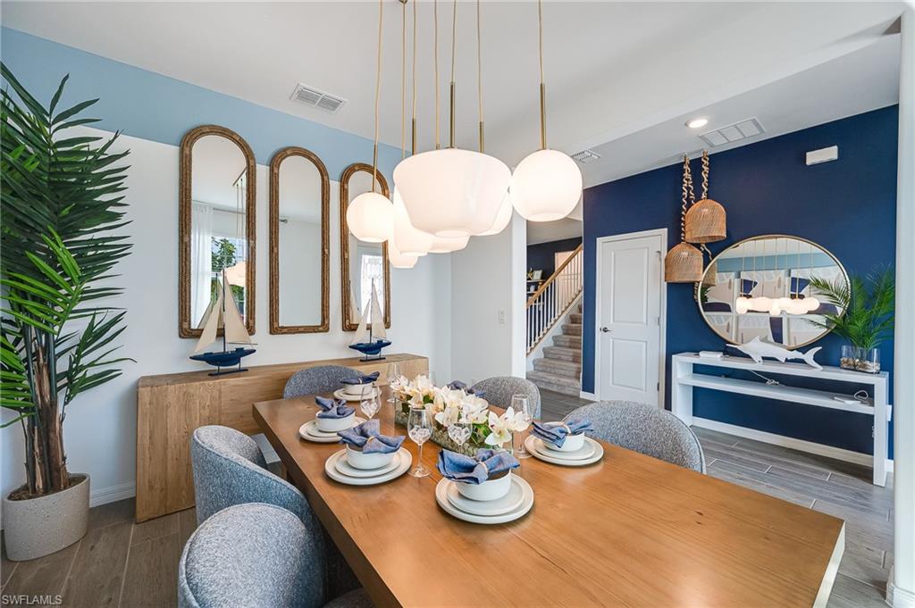 2318 Avocado Lane Naples, FL 34120 - Photo 14 of 47 a view of a dining room with furniture and a potted plant