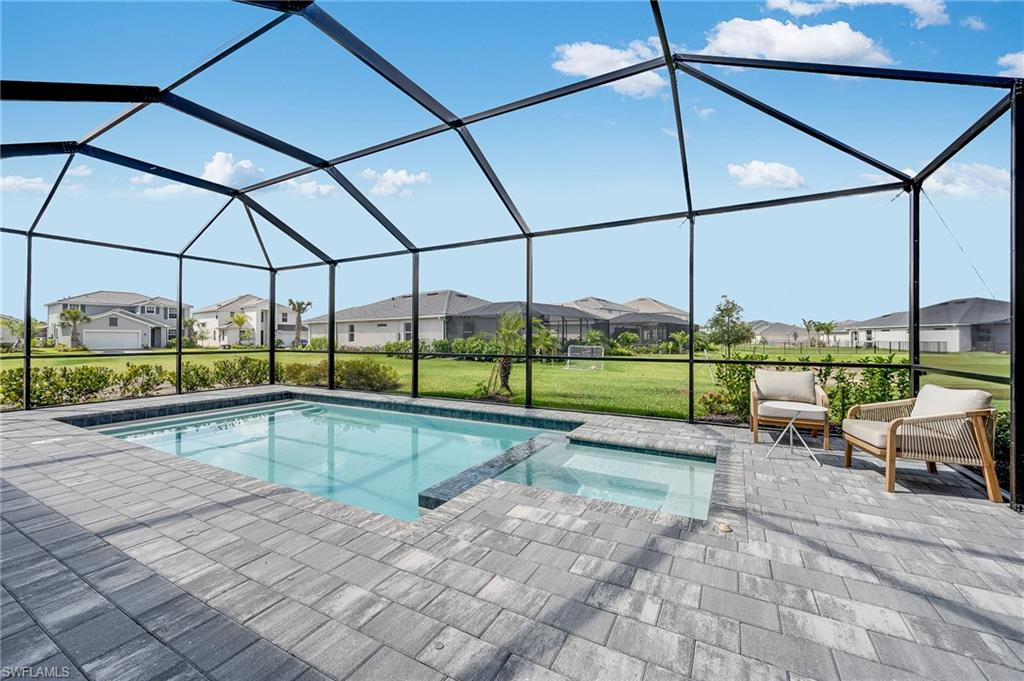 2318 Avocado Lane Naples, FL 34120 - Photo 16 of 47 a view of a swimming pool with a porch