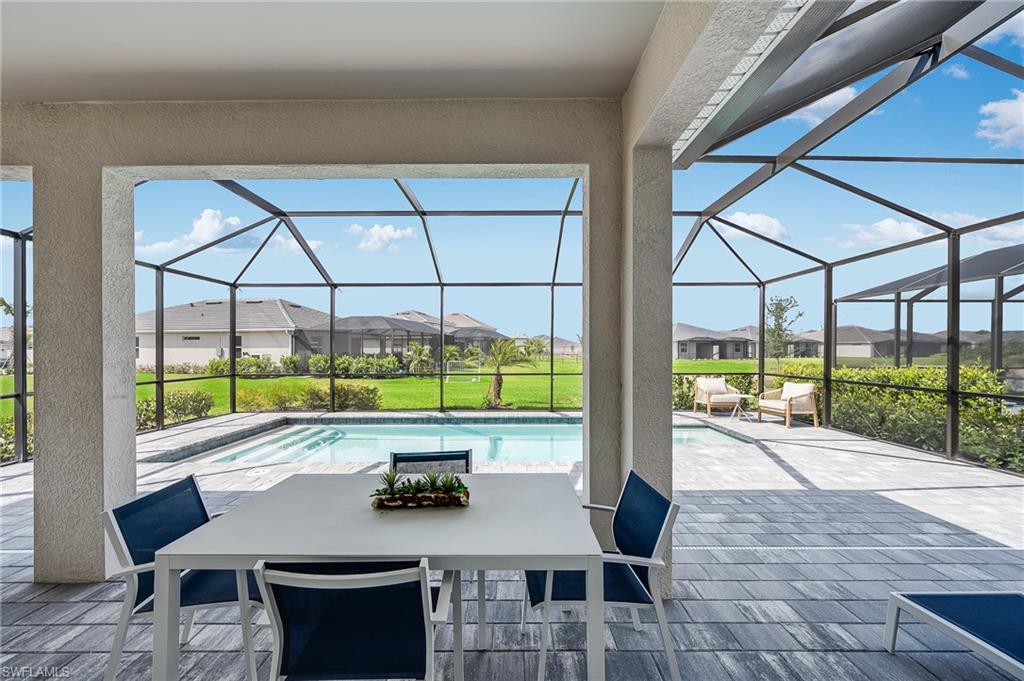 2318 Avocado Lane Naples, FL 34120 - Photo 17 of 47 a view of a patio with a table chairs and couches