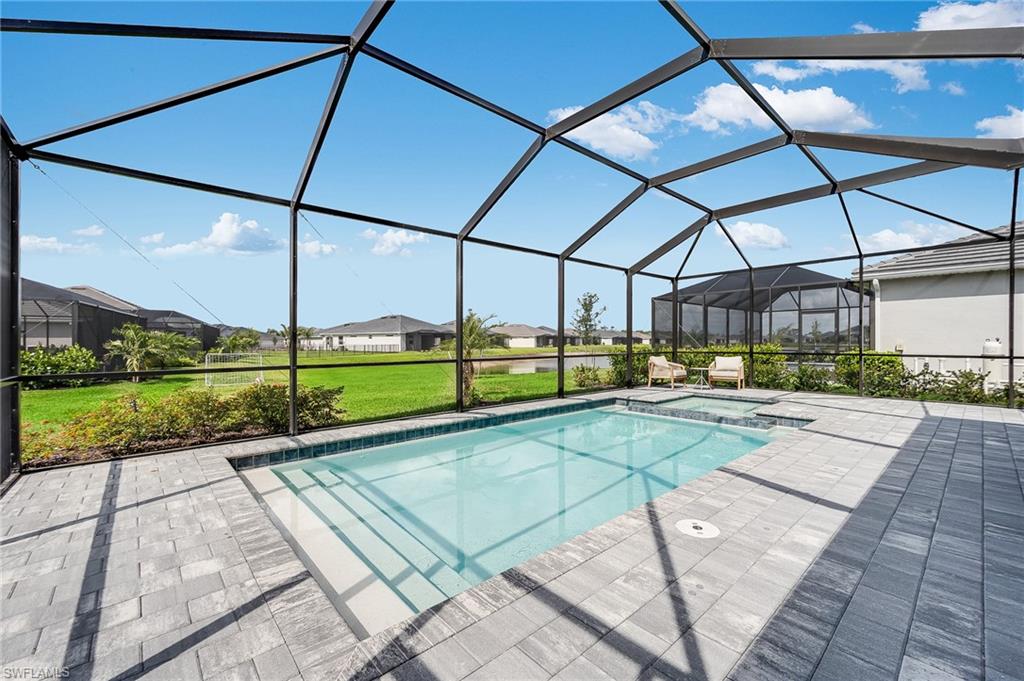 2318 Avocado Lane Naples, FL 34120 - Photo 18 of 47 a view of a swimming pool with a porch