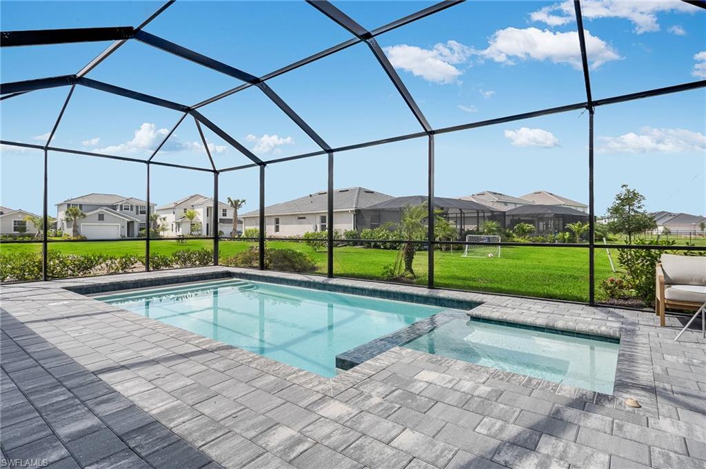 2318 Avocado Lane Naples, FL 34120 - Photo 19 of 47 a view of a swimming pool with a porch