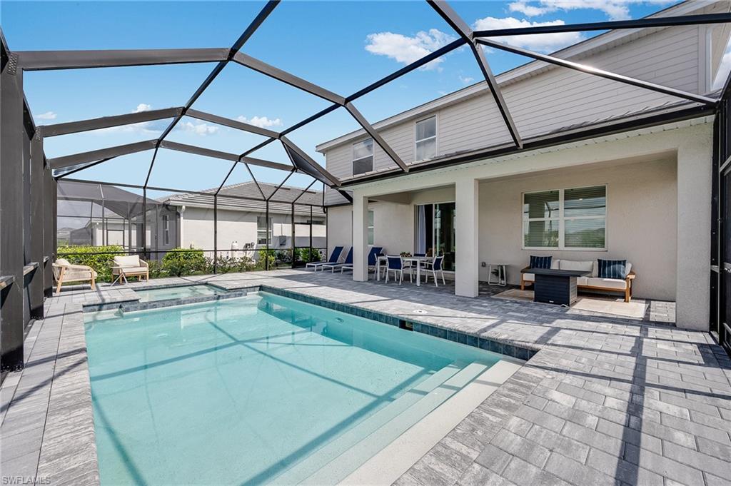 2318 Avocado Lane Naples, FL 34120 - Photo 20 of 47 a view of a patio with a table and chairs