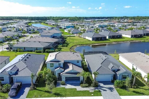 an aerial view of residential houses with outdoor space and swimming pool