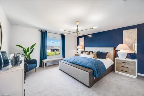 a spacious bedroom with a bed and ceiling fan