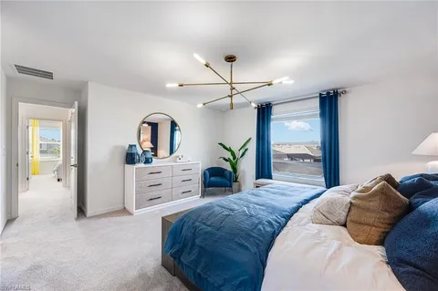 a bedroom with a large bed and a dresser