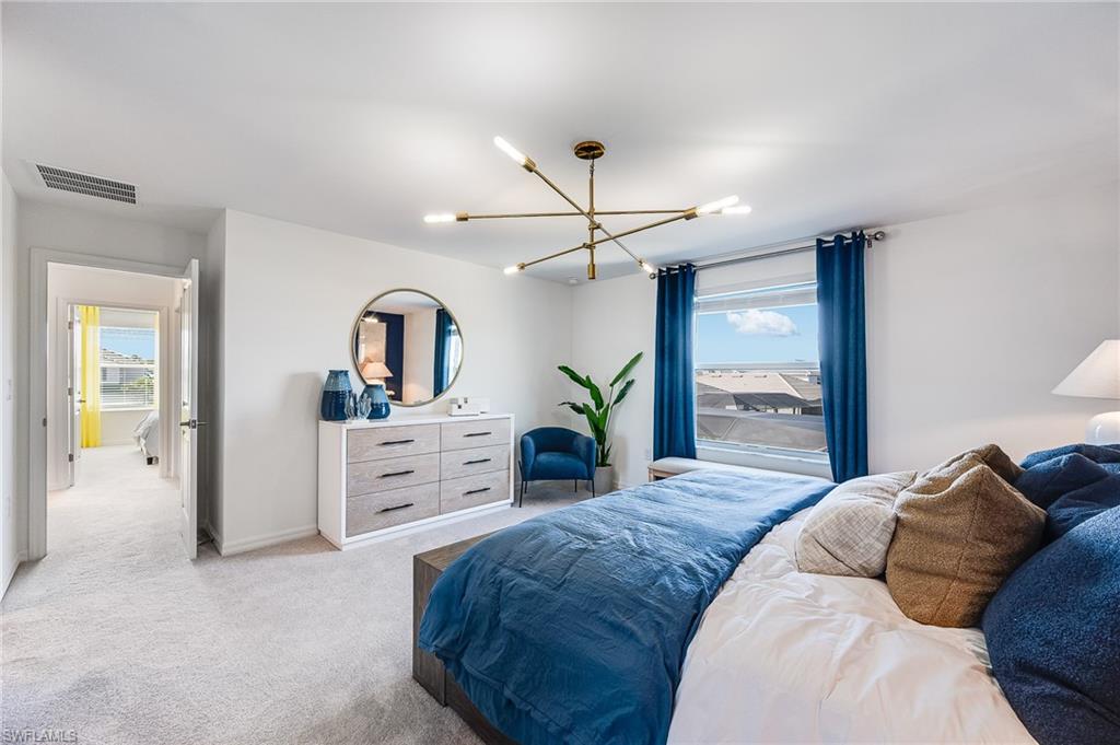 2318 Avocado Lane Naples, FL 34120 - Photo 23 of 47 a bedroom with a large bed and a dresser