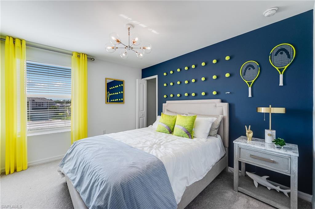 2318 Avocado Lane Naples, FL 34120 - Photo 26 of 47 a bedroom with a bed and a chandelier