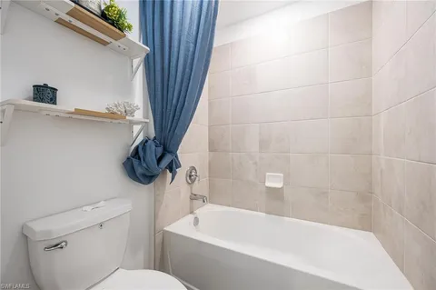 a bathroom with a toilet and a bathtub