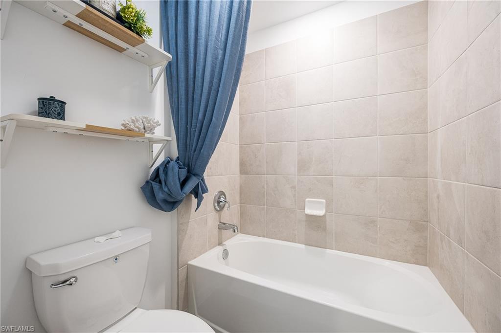 2318 Avocado Lane Naples, FL 34120 - Photo 27 of 47 a bathroom with a toilet and a bathtub