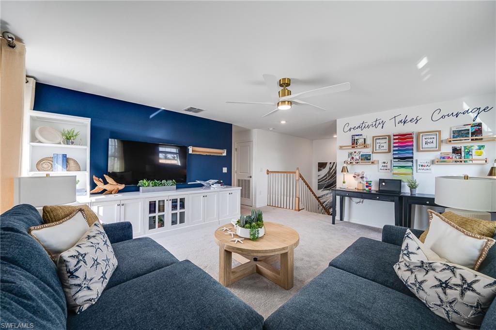 2318 Avocado Lane Naples, FL 34120 - Photo 28 of 47 a living room with furniture and a flat screen tv