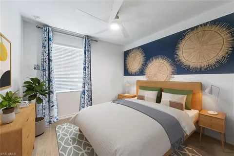 a bedroom with bed and a chandelier