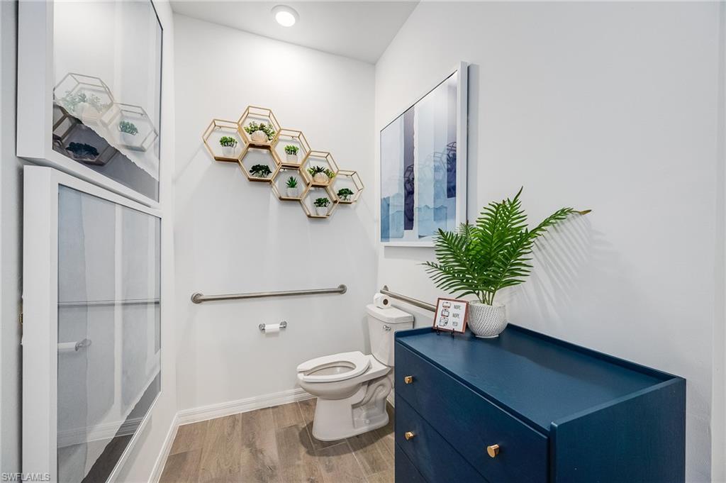 2318 Avocado Lane Naples, FL 34120 - Photo 32 of 47 a bathroom with a toilet a sink and mirror
