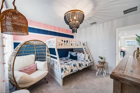 a bedroom with a bed a couch and dresser