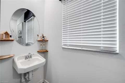 a bathroom with a sink a mirror and a shower
