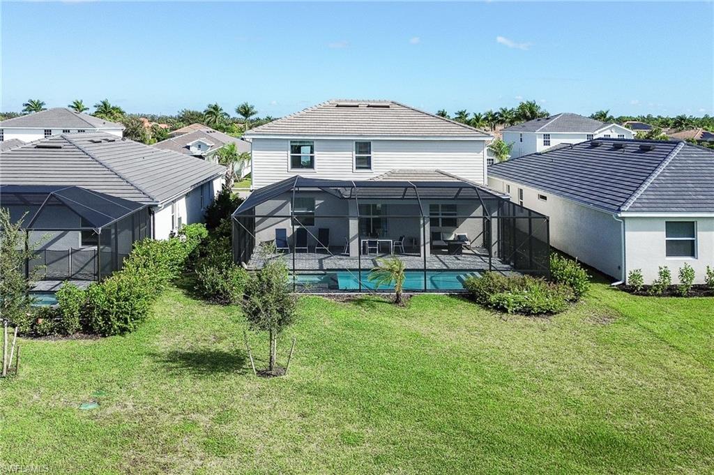 2318 Avocado Lane Naples, FL 34120 - Photo 40 of 47 front view of a house with a yard