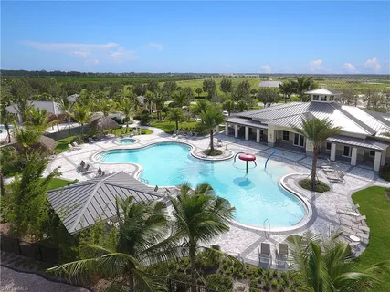 an aerial view of residential houses with outdoor space and swimming pool