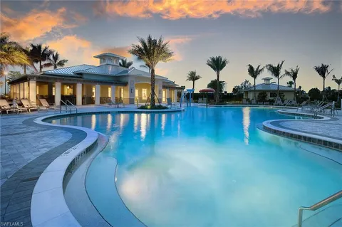 a view of a swimming pool with outdoor seating