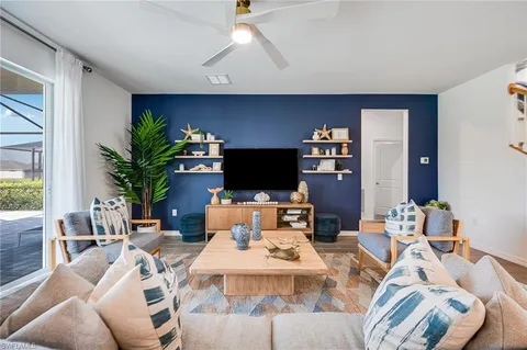 a living room with furniture a flat screen tv and a fireplace