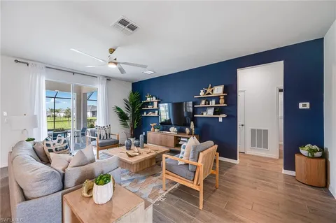 a living room with furniture or couch and a potted plant