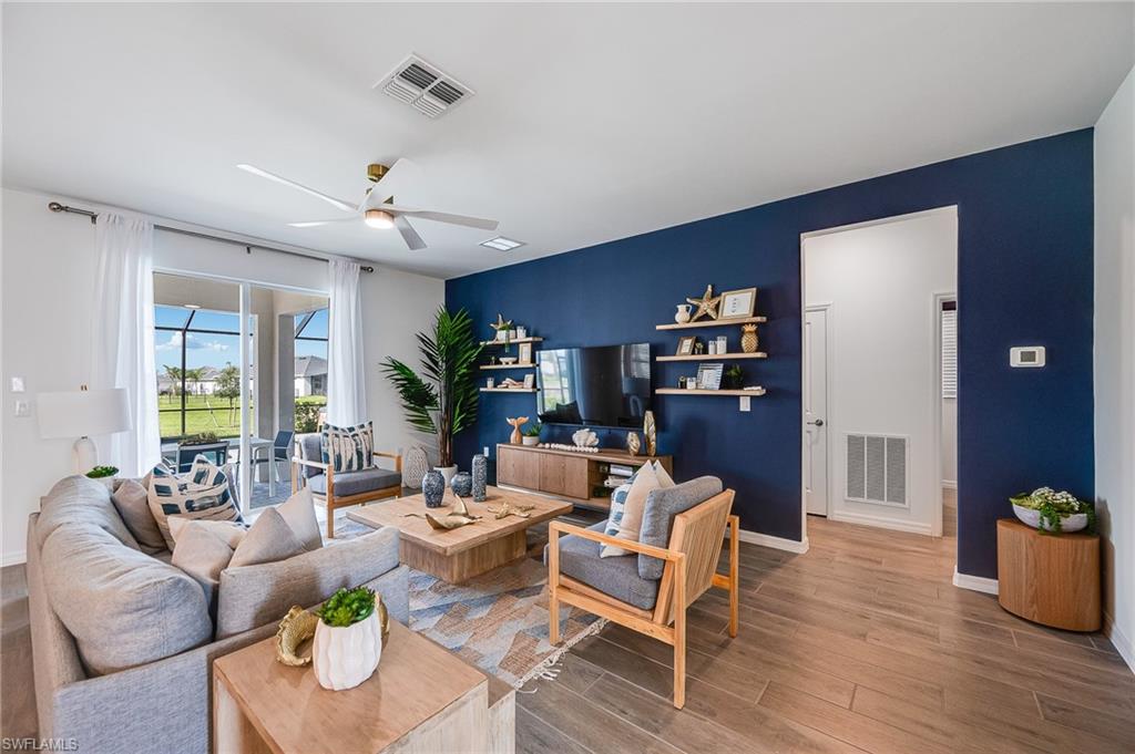 2318 Avocado Lane Naples, FL 34120 - Photo 6 of 47 a living room with furniture or couch and a potted plant